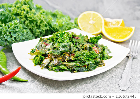 Kale cabbage with orange and pepper in plate on granite Kale cabbage with orange and pepper in plate on granite 110672445