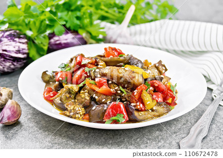 Ragout of eggplant with sweet peppers on granite table Ragout of eggplant with sweet peppers on granite table 110672478