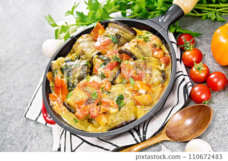 Rolls of eggplant with mincemeat in pan on gray stone Rolls of eggplant with mincemeat in pan on gray stone 110672483