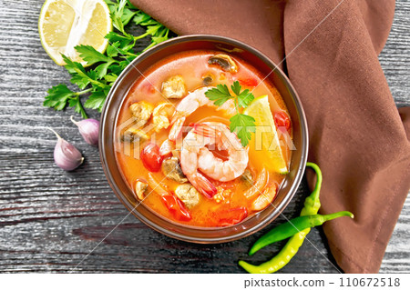 Soup Tom Yum with lemons in bowl on dark board top 110672518