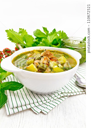 Soup with pisto sauce in bowl on light wooden board Soup with pisto sauce in bowl on light wooden board 110672521