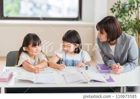 Elementary school students and instructors studying at a cram school. 110673585