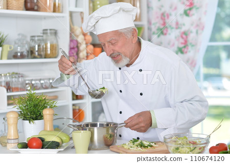 Portrait of chef preparing dinner at kitchen 110674120