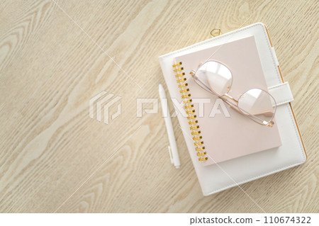 Business planning time management job organization concept stack of notepad on wooden table top view Business planning time management job organization concept stack of notepad on wooden table top view 110674322