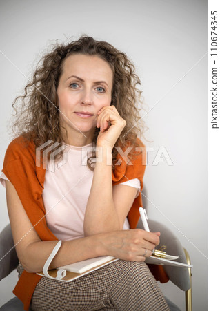 Smiling business woman psychologist relaxing enjoy break sitting on chair with notepad 110674345