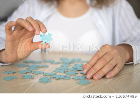 Business woman hands assembling puzzle details concept of finding solution solving problem top view 110674489
