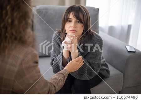 Sad woman crying at psychologist session female specialist help aid mental assistance closeup 110674490