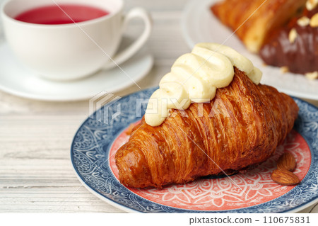 Fresh croissants with cup of tea on table Fresh croissants with cup of tea on table 110675831