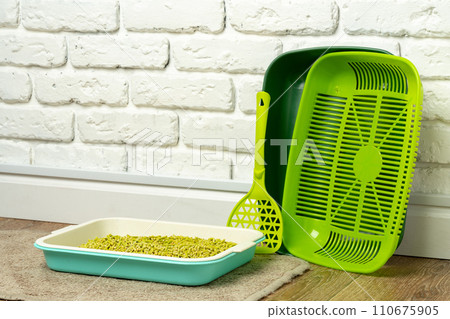 Plastic cat litter box in the bathroom 110675905