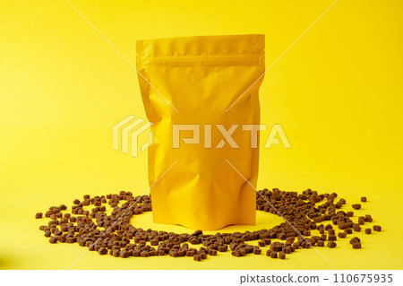Cat food on yellow background studio shot 110675935
