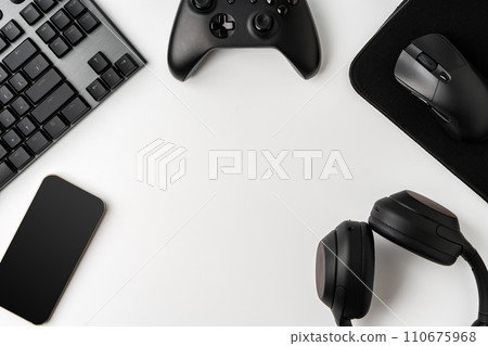 Top view of gamer table with computer keyboard, joystick and headphones Top view of gamer table with computer keyboard, joystick and headphones 110675968