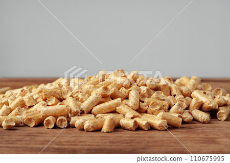 Heap of wooden pellets biofuel on wooden table 110675995