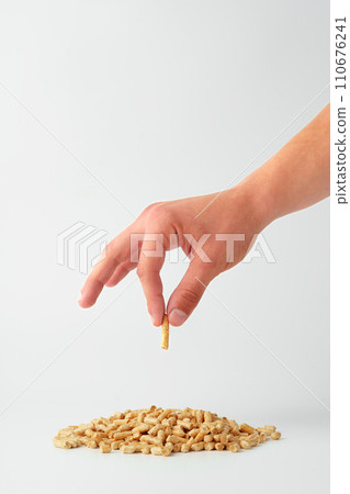 Human hands holding wooden pellets biofuel studio shot Human hands holding wooden pellets biofuel studio shot 110676241