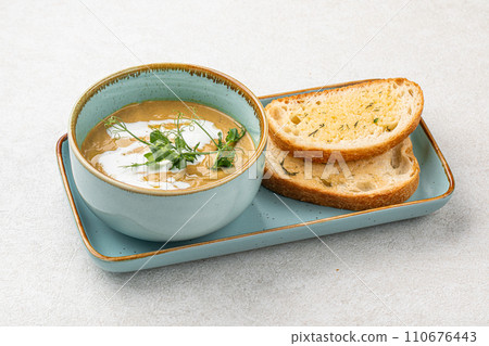 Portion of gourmet restaurant yellow pea soup 110676443