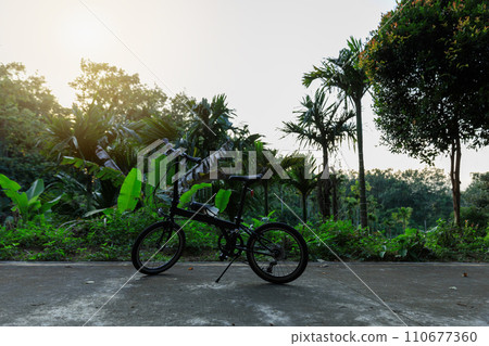 A folding bike on sunset road A folding bike on sunset road 110677360