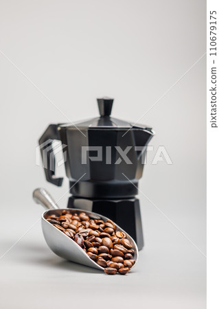 Roasted coffee beans in scoop on gray background. 110679175