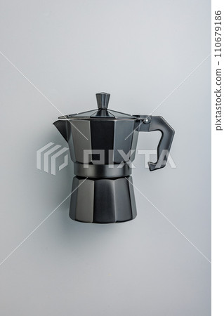 Bialetti moka pot. Coffee maker on gray background. Top view. Bialetti moka pot. Coffee maker on gray background. Top view. 110679186