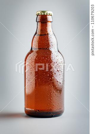 Beer bottle with drops on gray background. Beer bottle with drops on gray background. 110679203
