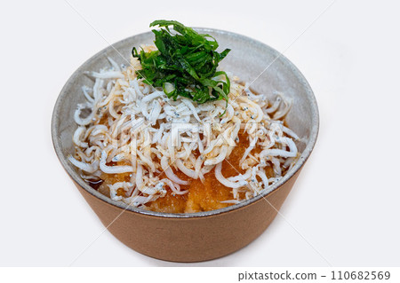 Grated whitebait on white background Grated whitebait on white background 110682569