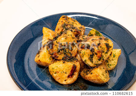 Seaweed salted butter potatoes served on a blue plate Seaweed salted butter potatoes served on a blue plate 110682615