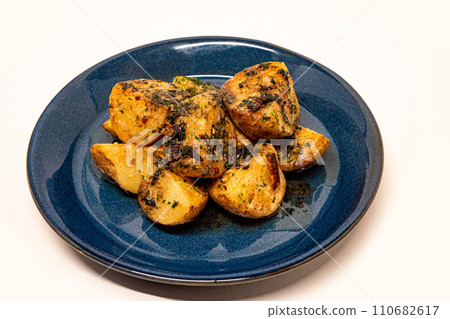 Seaweed salted butter potatoes served on a blue plate Seaweed salted butter potatoes served on a blue plate 110682617