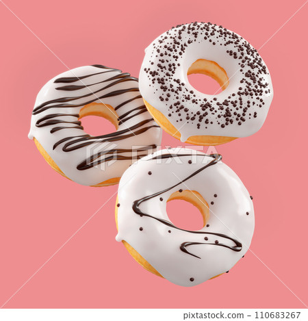 Chocolate glazed donut with sprinkles in motion falling on a pink background. 110683267