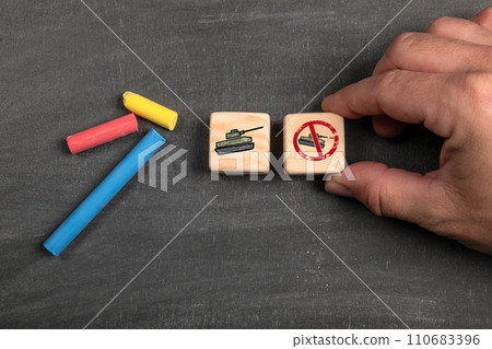 Stop War Concept. Wooden blocks on a dark chalkboard background Stop War Concept. Wooden blocks on a dark chalkboard background 110683396