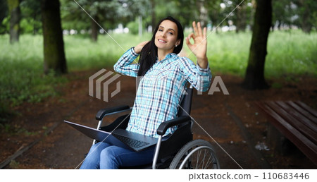 Woman in wheelchair show ok gesture with hand, work during rehabilitation Woman in wheelchair show ok gesture with hand, work during rehabilitation 110683446