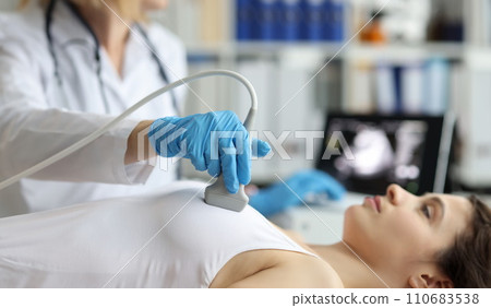 Doctor makes woman breast ultrasound, treatment before breast augmentation, full checkup in clinic Doctor makes woman breast ultrasound, treatment before breast augmentation, full checkup in clinic 110683538
