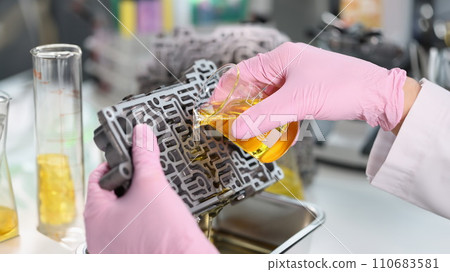 Male mechanic pour purified oil on automobile part, lubricating transport detail Male mechanic pour purified oil on automobile part, lubricating transport detail 110683581