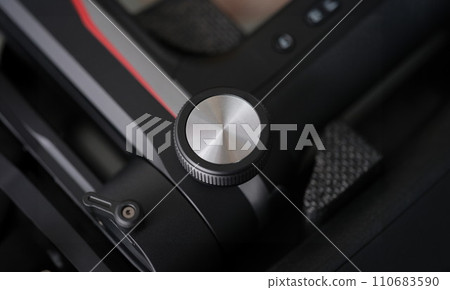 Black plastic vibration massager with control button closeup Black plastic vibration massager with control button closeup 110683590