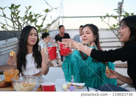 Happy group of young people drinking beer and having a good time together on a weekend day 110683736