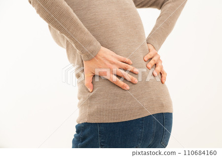 Middle women suffering from low back pain Middle women suffering from low back pain 110684160