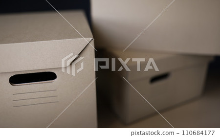 Empty solid cardboard boxes with covers, beige containers to storage things Empty solid cardboard boxes with covers, beige containers to storage things 110684177