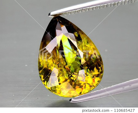 natural yellow sphene gem on the background 110685427