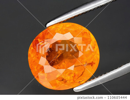 natural orange sapphire gem on the background 110685444