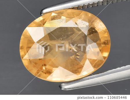 natural orange sapphire gem on the background natural orange sapphire gem on the background 110685446