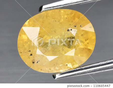 natural orange sapphire gem on the background natural orange sapphire gem on the background 110685447