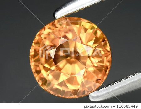 natural orange sapphire gem on the background natural orange sapphire gem on the background 110685449