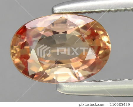 natural orange sapphire gem on the background natural orange sapphire gem on the background 110685459