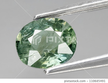 natural green sapphire gem on the background natural green sapphire gem on the background 110685491