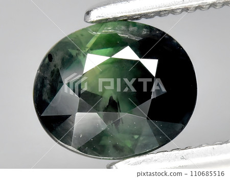 natural blue green sapphire gem on the background natural blue green sapphire gem on the background 110685516