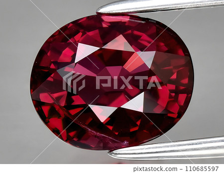 natural pink purple garnet rhodolite gem on the background 110685597