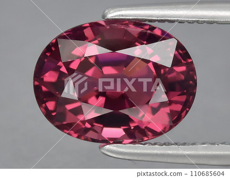 natural pink purple garnet rhodolite gem on the background 110685604