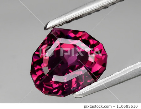 natural pink purple garnet rhodolite gem on the background natural pink purple garnet rhodolite gem on the background 110685610