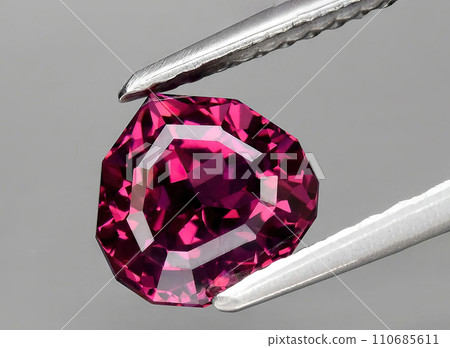 natural pink purple garnet rhodolite gem on the background 110685611