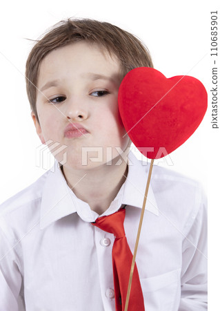 Child with Valentine. A boy with a red heart with a kiss. Child with Valentine. A boy with a red heart with a kiss. 110685901