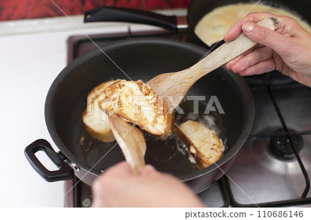 Fry white loaf croutons in a frying pan. Cook breakfast. Fry white loaf croutons in a frying pan. Cook breakfast. 110686146