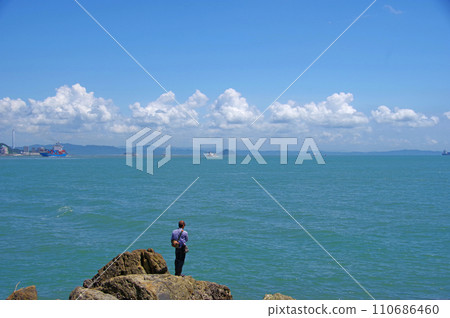 A person enjoying sea fishing in the Kanmon Strait in Kitakyushu City. 110686460