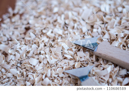 wood carving shavings and a cutter 110686589